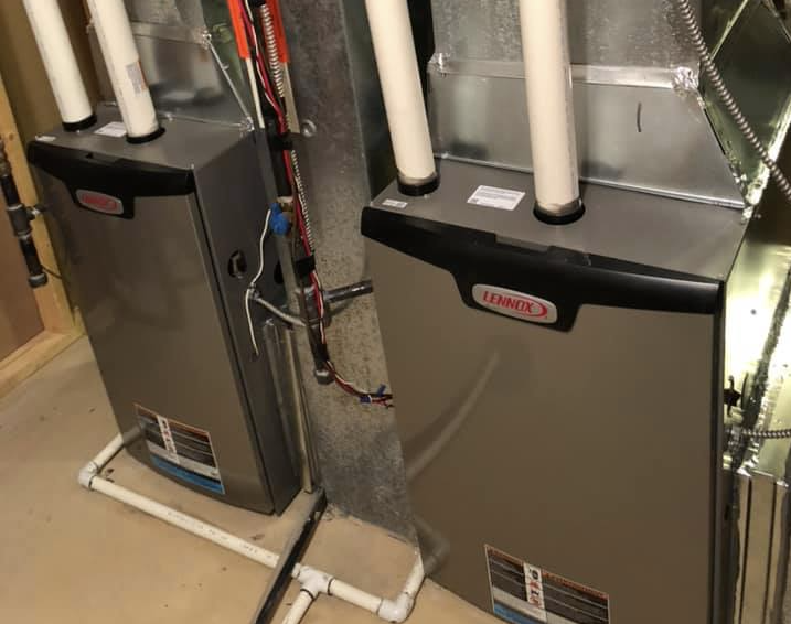 Tim and Ben servicing furnace equipment in Calgary home