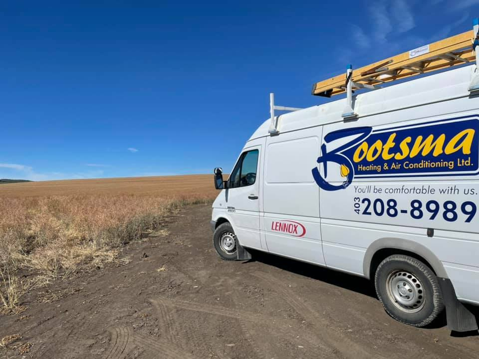 Tim and Ben Bootsma Calgary HVAC technicians with service truck - 30+ years professional heating and air conditioning expertise